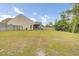 Large backyard featuring a green lawn, partial fencing, and views of the house's rear exterior at 3154 Hugh Bennett Dr, Johns Island, SC 29455