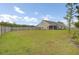Spacious backyard with a wooden fence, lush grass, and mature trees, ideal for outdoor activities at 3154 Hugh Bennett Dr, Johns Island, SC 29455