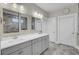 Bright bathroom features double vanity with gray cabinets, two mirrors, marble floor and gray walls at 3154 Hugh Bennett Dr, Johns Island, SC 29455