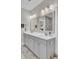 Bright bathroom features double vanity with gray cabinets, two mirrors, modern lighting and marble floor at 3154 Hugh Bennett Dr, Johns Island, SC 29455