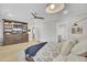 Well-lit bedroom featuring wood floors, a ceiling fan, a large dresser, and an expansive bookshelf at 3154 Hugh Bennett Dr, Johns Island, SC 29455