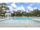 Community pool surrounded by lounge chairs, umbrellas, and fountain for relaxation and recreation at 3154 Hugh Bennett Dr, Johns Island, SC 29455