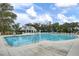 Community pool with clear blue water, surrounded by chairs, umbrellas, and pool house at 3154 Hugh Bennett Dr, Johns Island, SC 29455