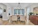 Light filled dining room featuring a modern chandelier, large windows, and wood floors at 3154 Hugh Bennett Dr, Johns Island, SC 29455