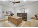 Bright home office featuring a large wooden desk, ceiling fan, and a built-in bookcase with glass doors at 3154 Hugh Bennett Dr, Johns Island, SC 29455