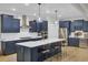Modern kitchen with navy cabinets, stainless steel appliances, and a large island with seating at 3154 Hugh Bennett Dr, Johns Island, SC 29455