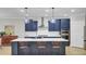 Modern kitchen features a large island with seating, stainless steel appliances, and stylish pendant lighting at 3154 Hugh Bennett Dr, Johns Island, SC 29455
