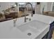 Farmhouse sink with gooseneck faucet on an island with living room and dining room views at 3154 Hugh Bennett Dr, Johns Island, SC 29455