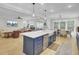 Open concept kitchen with island seating, dining area, and living room with modern finishes and hardwood flooring at 3154 Hugh Bennett Dr, Johns Island, SC 29455
