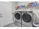 Modern laundry room featuring front-load washer/dryer set and ample shelving space at 3154 Hugh Bennett Dr, Johns Island, SC 29455