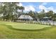Enjoy a perfectly manicured putting green with clubhouse view at 3154 Hugh Bennett Dr, Johns Island, SC 29455