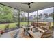 Inviting screened porch with comfortable seating, ceiling fan, and views of the backyard at 3154 Hugh Bennett Dr, Johns Island, SC 29455