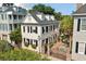 Aerial view of a charming home with a brick patio, American flag, and lush landscaping at 32 Church St, Charleston, SC 29401