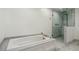 Bathroom features a soaking tub with marble trim and a glass-enclosed shower at 32 Church St, Charleston, SC 29401