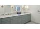 Bathroom featuring double sinks with gray vanity cabinets and marble countertops at 32 Church St, Charleston, SC 29401