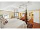 A bright bedroom with a four poster bed, hardwood floors, and white ceiling at 32 Church St, Charleston, SC 29401