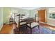 Elegant bedroom showcases a four-poster bed, antique chest, and stylish rug at 32 Church St, Charleston, SC 29401