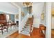 Inviting foyer with wood floors, decorative staircase, and chandelier at 32 Church St, Charleston, SC 29401