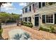 Charming home with classic black shutters, a brick walkway, and a well-manicured lawn at 32 Church St, Charleston, SC 29401