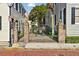 Elegant brick and iron gate providing access to a courtyard garden at 32 Church St, Charleston, SC 29401