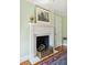 Charming fireplace with decorative mantle, marble hearth, and traditional log holder at 32 Church St, Charleston, SC 29401