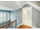 Hallway view showing natural light from a window and doorway to a bright bathroom at 32 Church St, Charleston, SC 29401