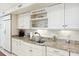 Bright kitchen features white cabinets, granite countertops, and stainless steel appliances at 32 Church St, Charleston, SC 29401