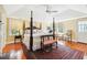 Serene main bedroom features a four-poster bed, hardwood floors, and plenty of natural light at 32 Church St, Charleston, SC 29401