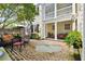 Charming brick patio with outdoor seating surrounded by lush greenery and a yellow exterior at 32 Church St, Charleston, SC 29401