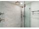 Bright shower with frameless glass, dual shower heads, and marble tile design at 32 Church St, Charleston, SC 29401