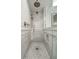 Close-up of a marble tiled shower with rainfall shower head and built in niche at 32 Church St, Charleston, SC 29401
