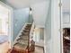 Inviting stairway with decorative runner and natural light creating a warm welcome at 32 Church St, Charleston, SC 29401