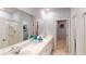 Bright bathroom features a double vanity with a large mirror, linen closet, and tile flooring at 325 Pine Crest View, Summerville, SC 29486
