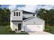 Charming two-story home with a light blue exterior, two-car garage, and a neatly landscaped front yard at 325 Pine Crest View, Summerville, SC 29486
