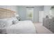 Serene main bedroom featuring a plush bed, neutral tones, and a dresser, offering a comfortable and stylish retreat at 325 Pine Crest View, Summerville, SC 29486