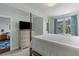 Inviting bedroom featuring soft colors, large dresser with TV, and an abundance of natural light at 33 Calhoun St # 123, Charleston, SC 29401