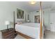 Bright bedroom with king bed, a nightstand with lamp and ensuite bathroom at 33 Calhoun St # 123, Charleston, SC 29401