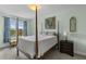 Serene bedroom with four poster bed, blue accent curtains and neutral tones for a peaceful retreat at 33 Calhoun St # 123, Charleston, SC 29401