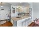 Bright kitchen with granite countertops and a breakfast bar that opens to dining room at 33 Calhoun St # 123, Charleston, SC 29401