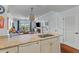 Open kitchen with granite countertops overlooks the living area with balcony access at 33 Calhoun St # 123, Charleston, SC 29401
