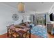 Open-concept living room with dining area featuring modern decor and balcony access at 33 Calhoun St # 123, Charleston, SC 29401