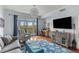 Comfortable living room with eclectic furnishings and a view of the outdoor balcony space at 33 Calhoun St # 123, Charleston, SC 29401