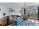 Bright living room featuring hardwood floors, stylish furniture and sliding glass doors to balcony at 33 Calhoun St # 123, Charleston, SC 29401