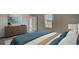 Cozy bedroom with large window, stylish dresser, and teal accent pillows and comforter at 331 Pine Crest View, Summerville, SC 29486