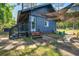 Exterior view of a charming home with blue siding, stone pathways, and lush landscaping around the property at 3389 Prices Bridge Ln, Walterboro, SC 29488