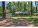 Charming single-story home with a metal roof, surrounded by mature trees and a lush green yard at 3389 Prices Bridge Ln, Walterboro, SC 29488