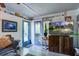 Cozy living room with blue french doors, natural light, and a decorative television console at 3389 Prices Bridge Ln, Walterboro, SC 29488