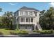 Charming two-story home with a covered porch, two car garage, and beautifully landscaped front yard at 347 Simone Dr, Daniel Island, SC 29492