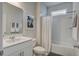 Well-lit bathroom with a single sink vanity, a framed art piece, and a bathtub with a shower curtain at 349 Long Pier St, Summerville, SC 29486