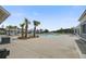 A refreshing community pool surrounded by palm trees and lounge chairs offers a resort-like ambiance at 349 Long Pier St, Summerville, SC 29486